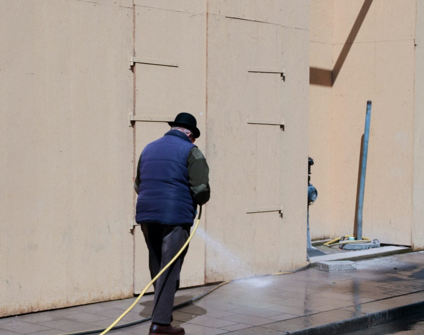 Professional pressure washing of an exterior walkway and building surface near me