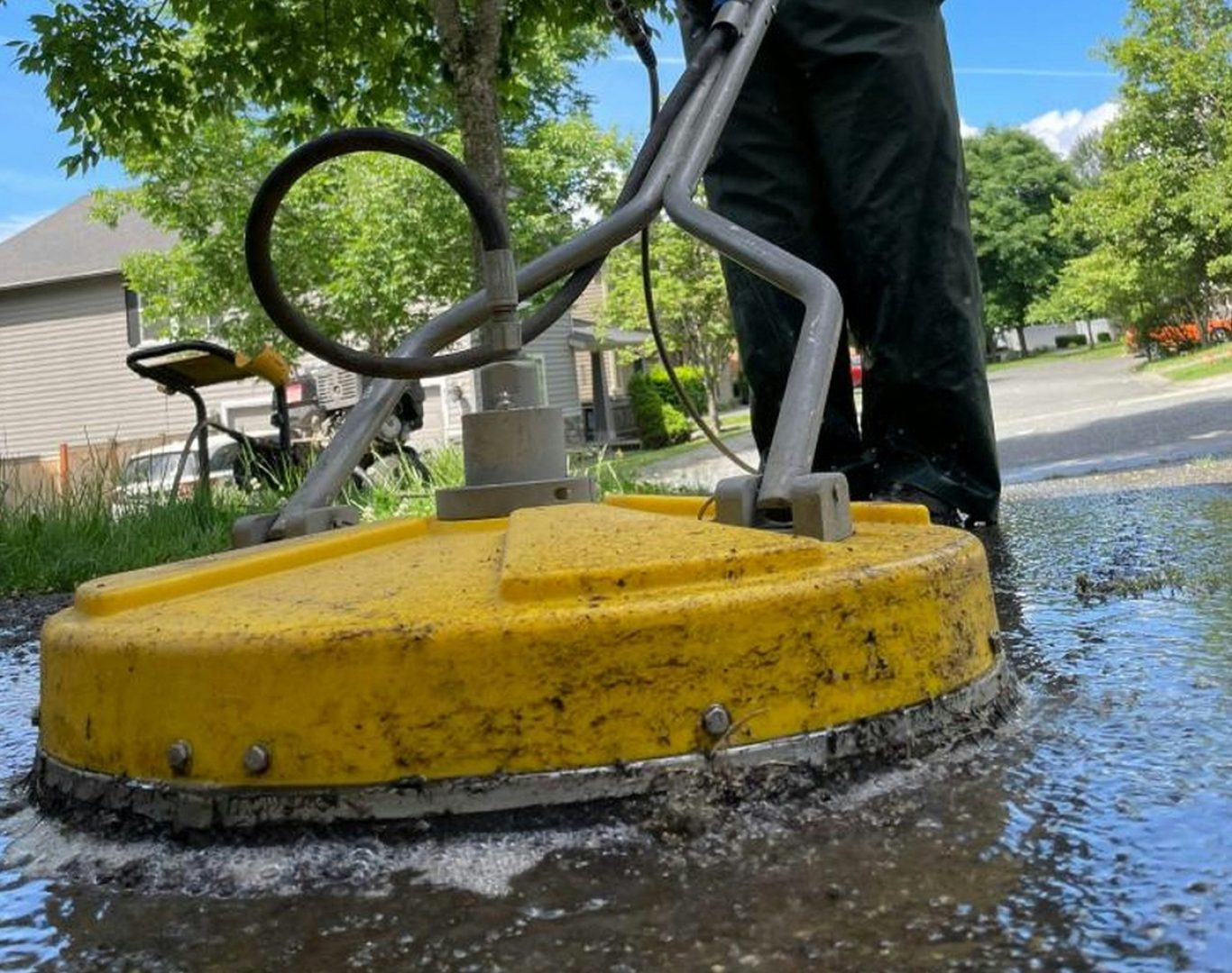 Professional surface cleaner pressure washing a residential driveway near me